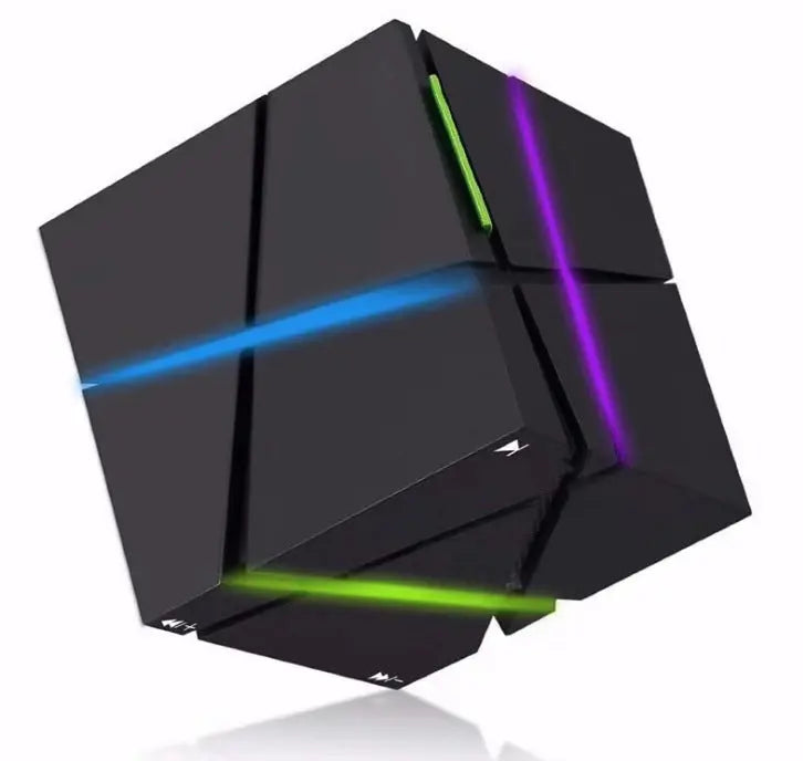 The Dropshipman CubeSync Rubik Cube Bluetooth Speaker is a black geometric puzzle cube with blue, green, and purple lines on its facets, resembling a futuristic Rubik’s Cube, shown against a white background.