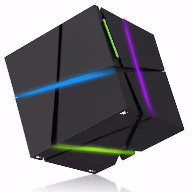 The Dropshipman CubeSync Rubik Cube Bluetooth Speaker is a black geometric puzzle cube with blue, green, and purple lines on its facets, resembling a futuristic Rubik’s Cube, shown against a white background.