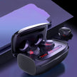 A pair of FLIPSTYLEZLLC T11 Wireless Bluetooth Headset 5.0 Earbuds in black, shown with an open charging case featuring red LED lights on a reflective surface, one earbud outside the case, next to a purple item.