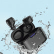 FLIPSTYLEZLLC Subwoofer Class 7 Waterproof True Wireless Earbuds In-Ear TWS Bluetooth Headphones are shown in an open case with four blue LED lights, surrounded by splashing water on a light blue background, highlighting stereo sound and multi-point connection.